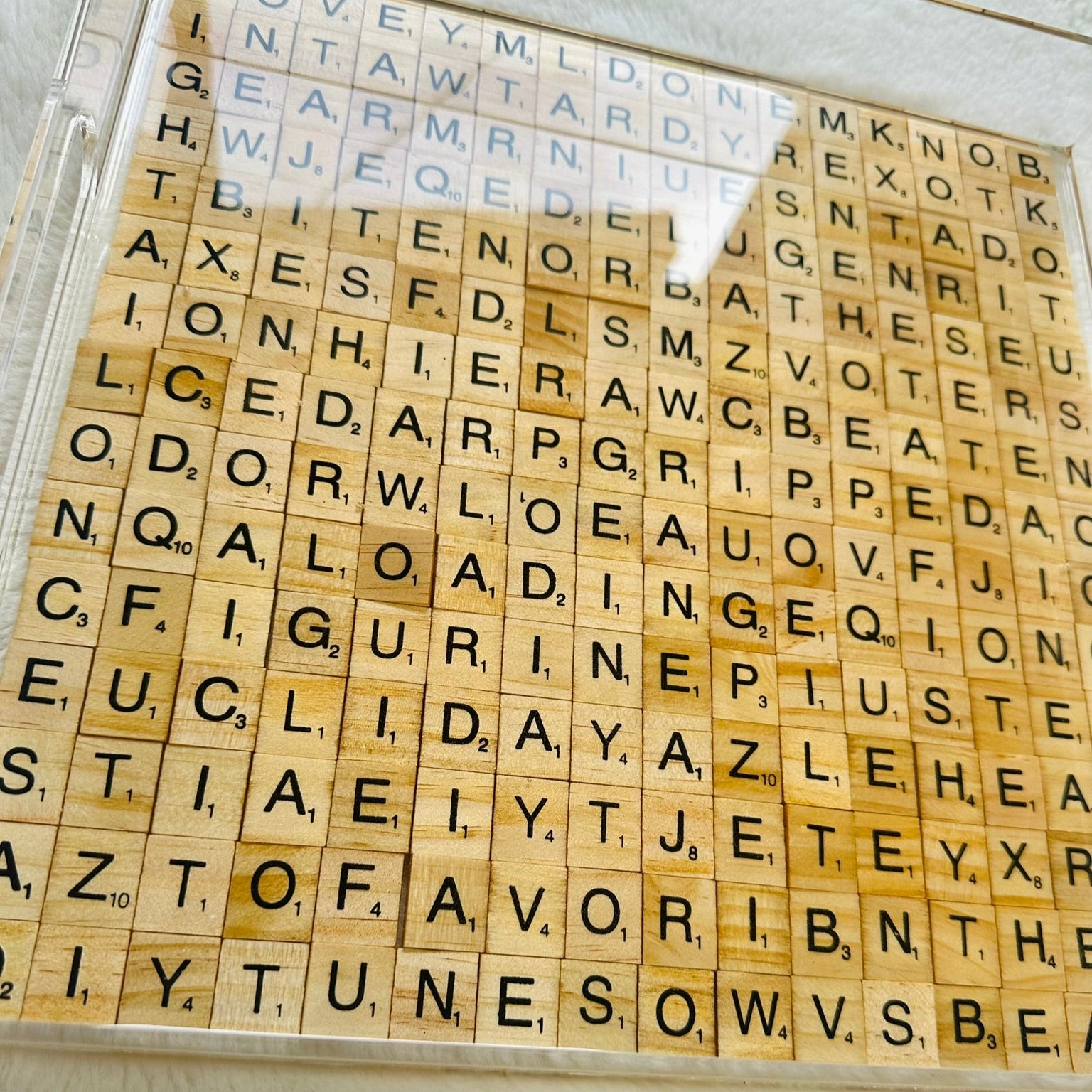 Wooden Scrabble letter tiles with scrabble-style design and hidden words in acrylic tray filled with epoxy resin.