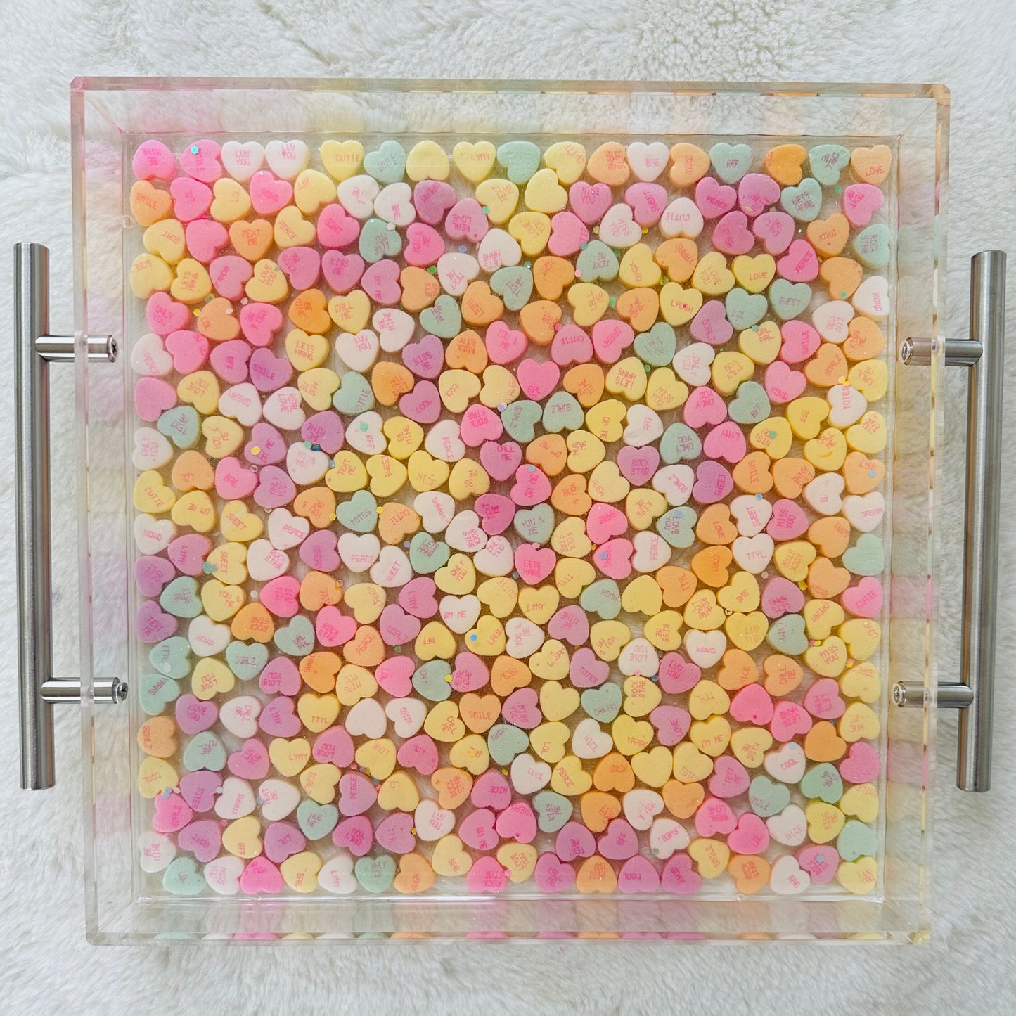 candy conversation hearts in a clear acrylic tray sealed in epoxy resin. handmade