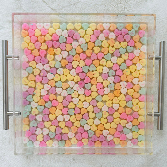 candy conversation hearts in a clear acrylic tray sealed in epoxy resin. handmade