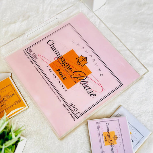Pink and orange packaging with 'Champagne Please' branding on a white surface.